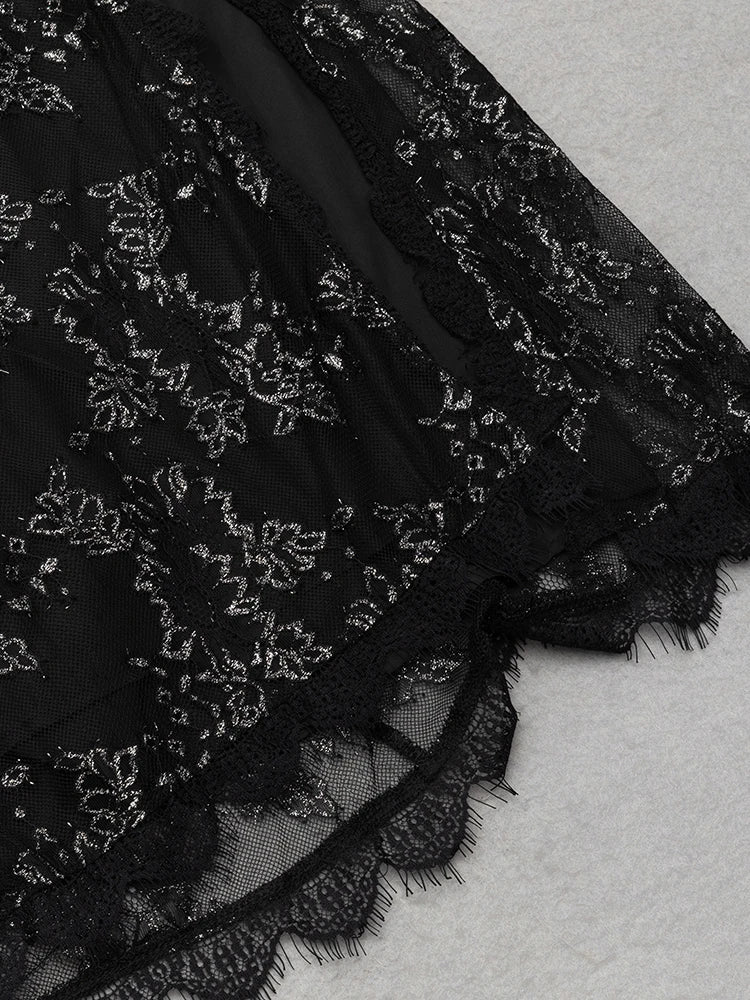 Black lace fabric with intricate patterns on a textured surface