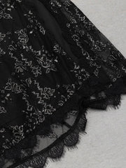 Black lace fabric with intricate patterns on a textured surface