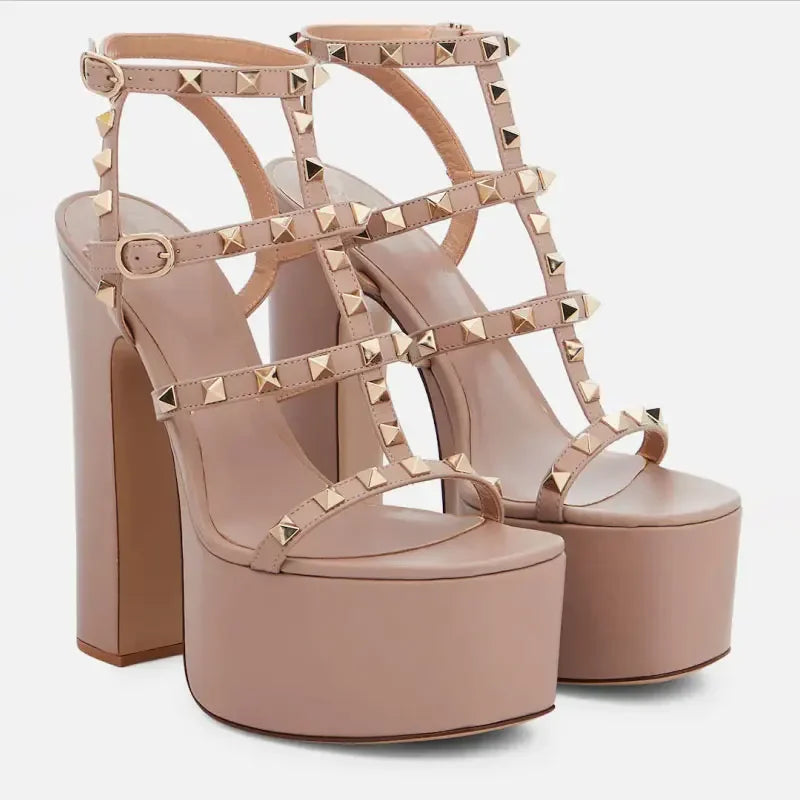 Beige platform high-heeled sandals with studded details on a white background