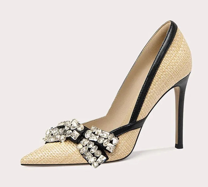 High-heeled shoe with decorative strap on a light gray background