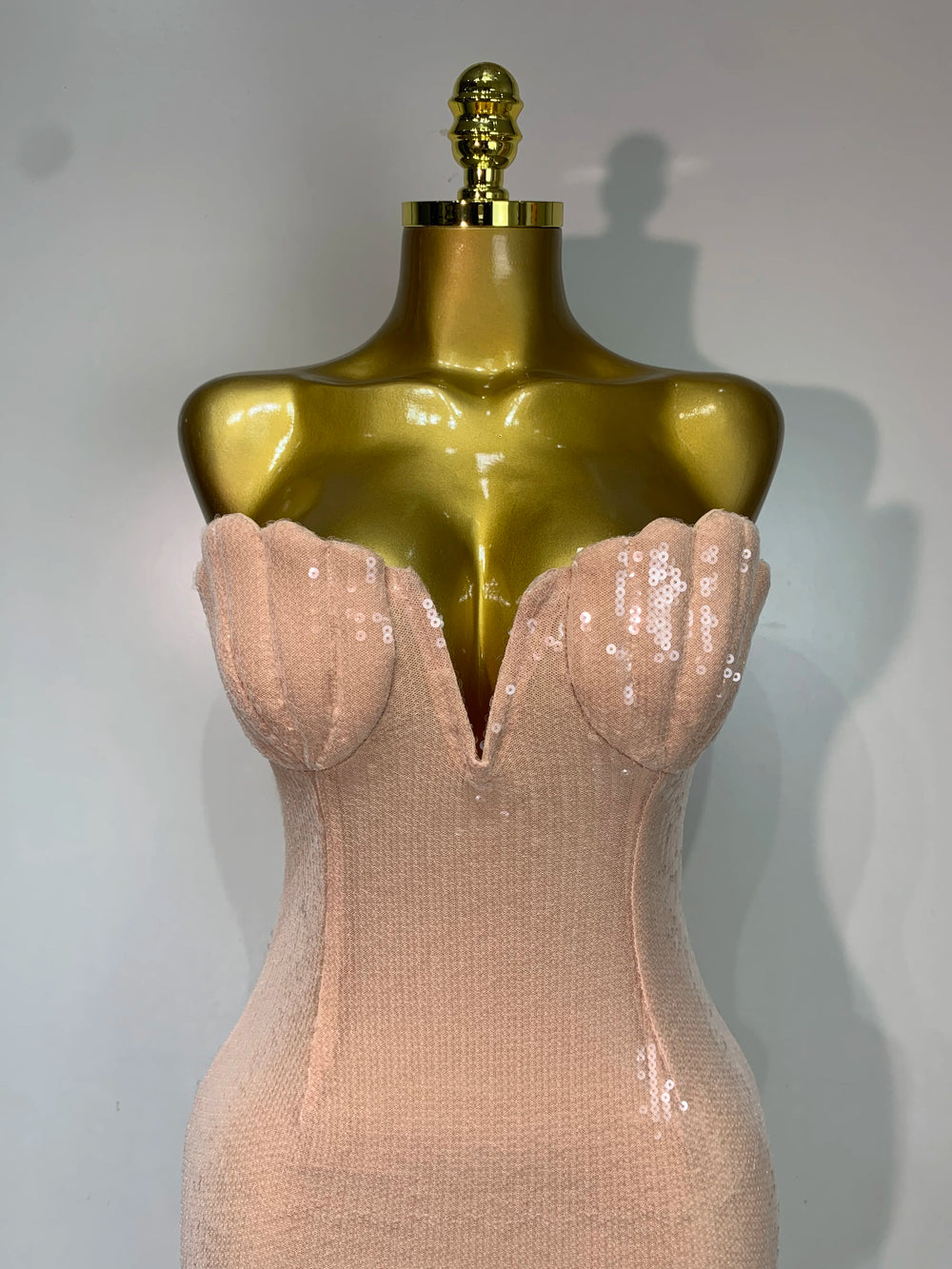 Close-up of the strapless V-neck sequin detailing on a maxi dress
