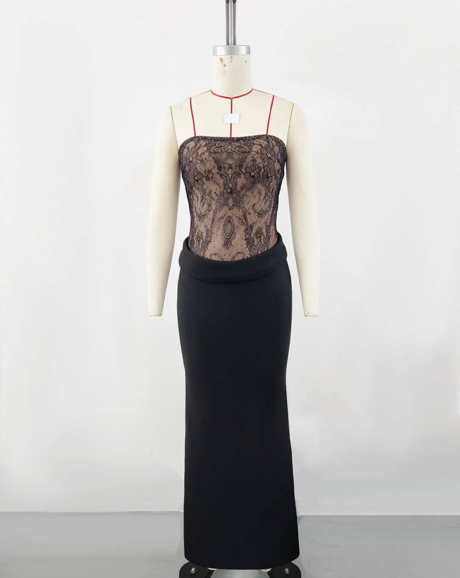 Mannequin wearing a black lace top and black pencil skirt