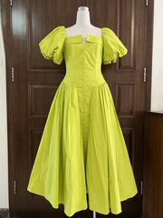 Yellow dress on a mannequin against a wooden door background