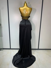 Back view of gold metallic corset top and black draped skirt two-piece set