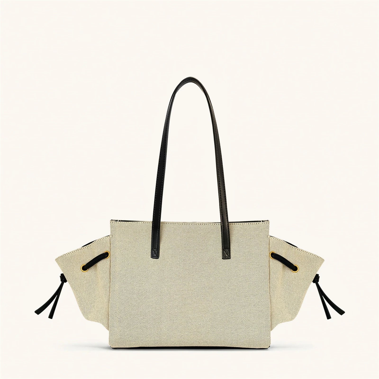 Beige tote bag with black handles and straps on a white background