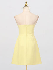 Yellow strapless dress on a mannequin against a white background