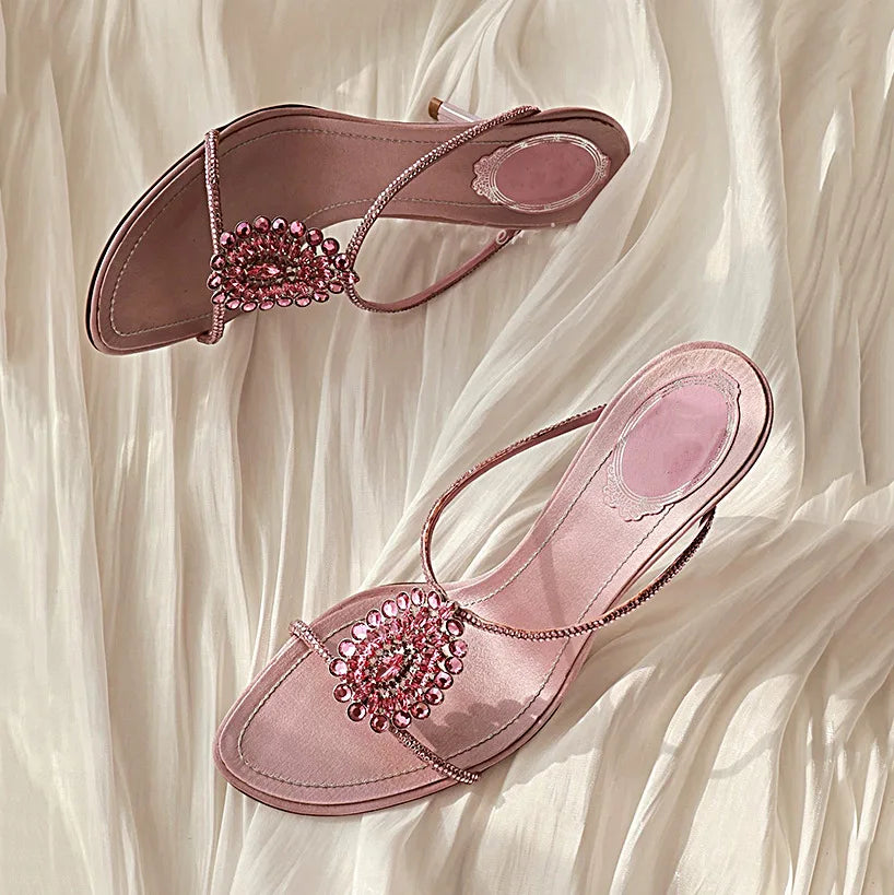 Close-up of the crystal embellishment on thin heel sandals.