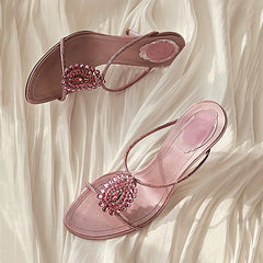 Close-up of the crystal embellishment on thin heel sandals.