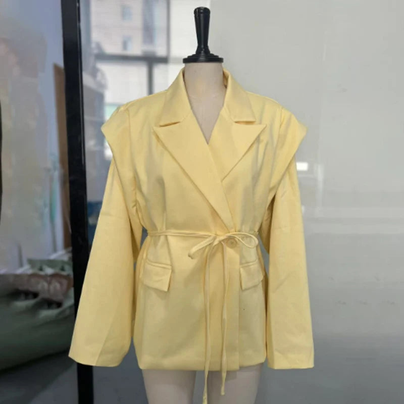 Yellow jacket on a mannequin against a white background