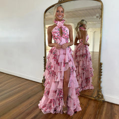 Model wearing a pink floral print ruffled swimsuit and skirt