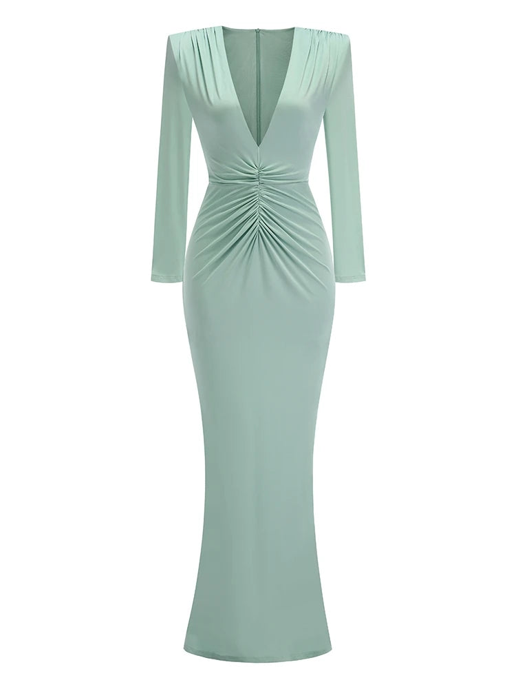 Mint green dress with long sleeves on a white background