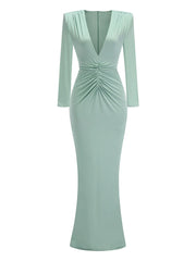 Mint green dress with long sleeves on a white background