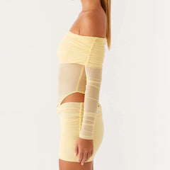 Yellow dress with mesh panels on a plain background