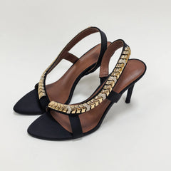 Pair of black slingback heels with gold chain and rhinestone detail