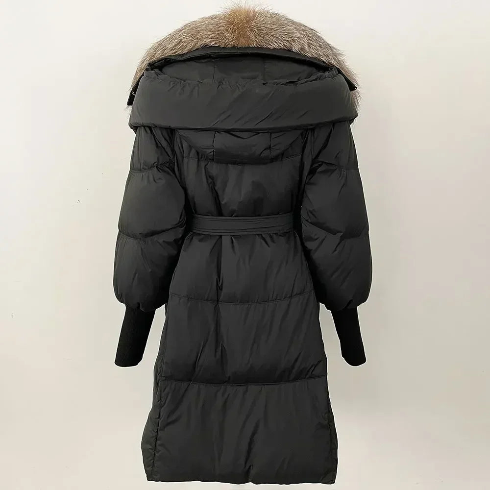 Black puffer coat with fur hood on a light beige background