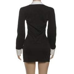 Black dress with white cuffs and collar on a mannequin against a white background