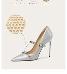 Silver high-heeled shoe with embellishments on a white background