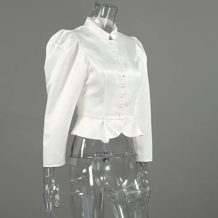 White blouse on a transparent mannequin against a gray background