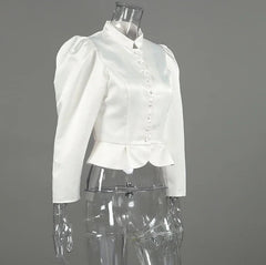 White blouse on a transparent mannequin against a gray background