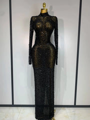 Black beaded evening gown on a mannequin against a white wall.
