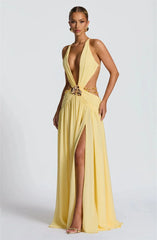 Yellow evening gown with a high slit on a white background