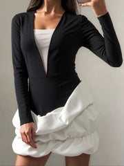 Structured black dress with white puff detail at the hem