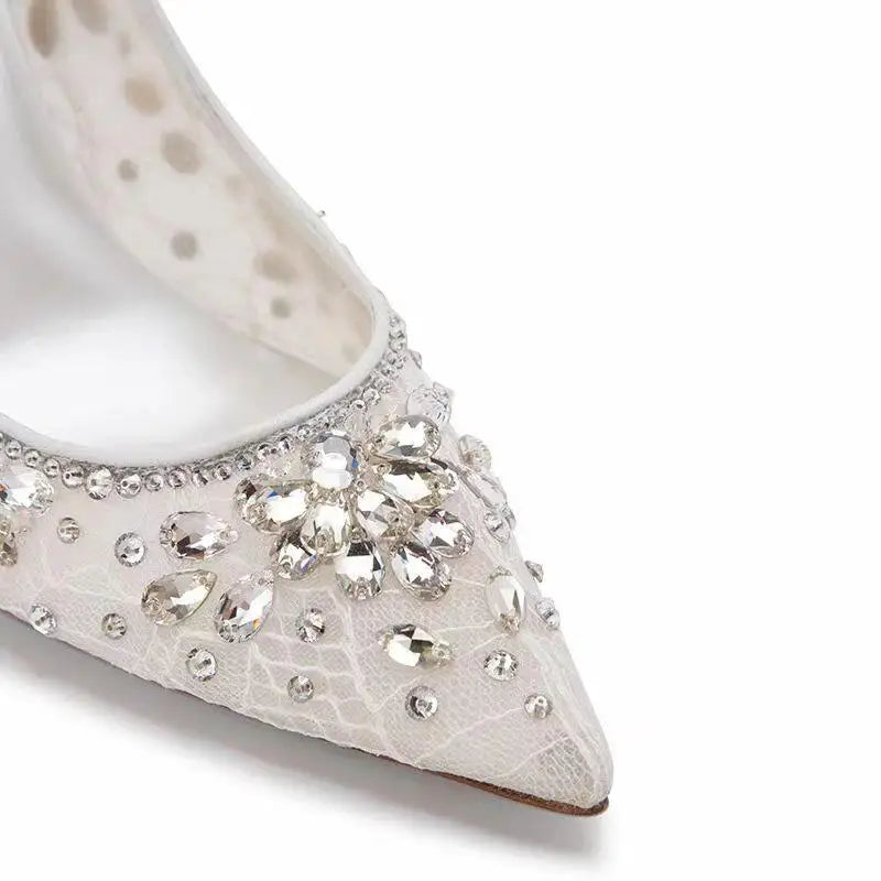 White shoe with crystal embellishments on a white background