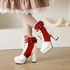 Red and white platform shoes with ruffles worn by a person in a beige skirt.