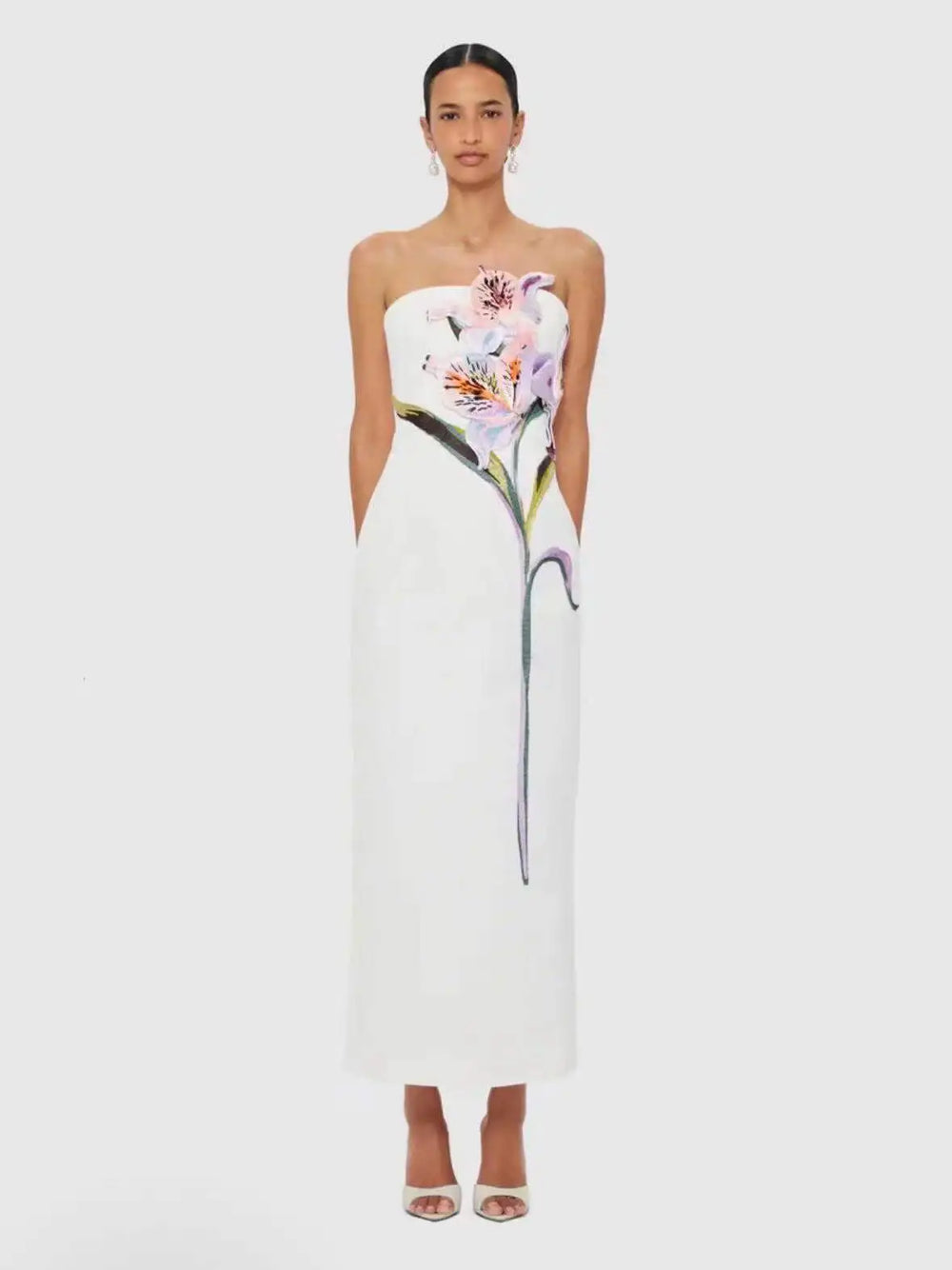 Strapless column maxi dress with floral appliqué in white.