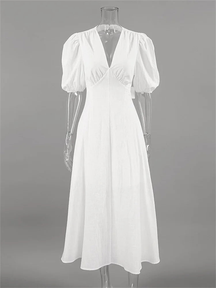 White dress on a mannequin against a gray background