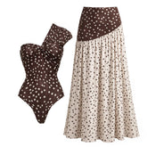 Polka dot one-piece swimsuit and flowing maxi skirt displayed together.