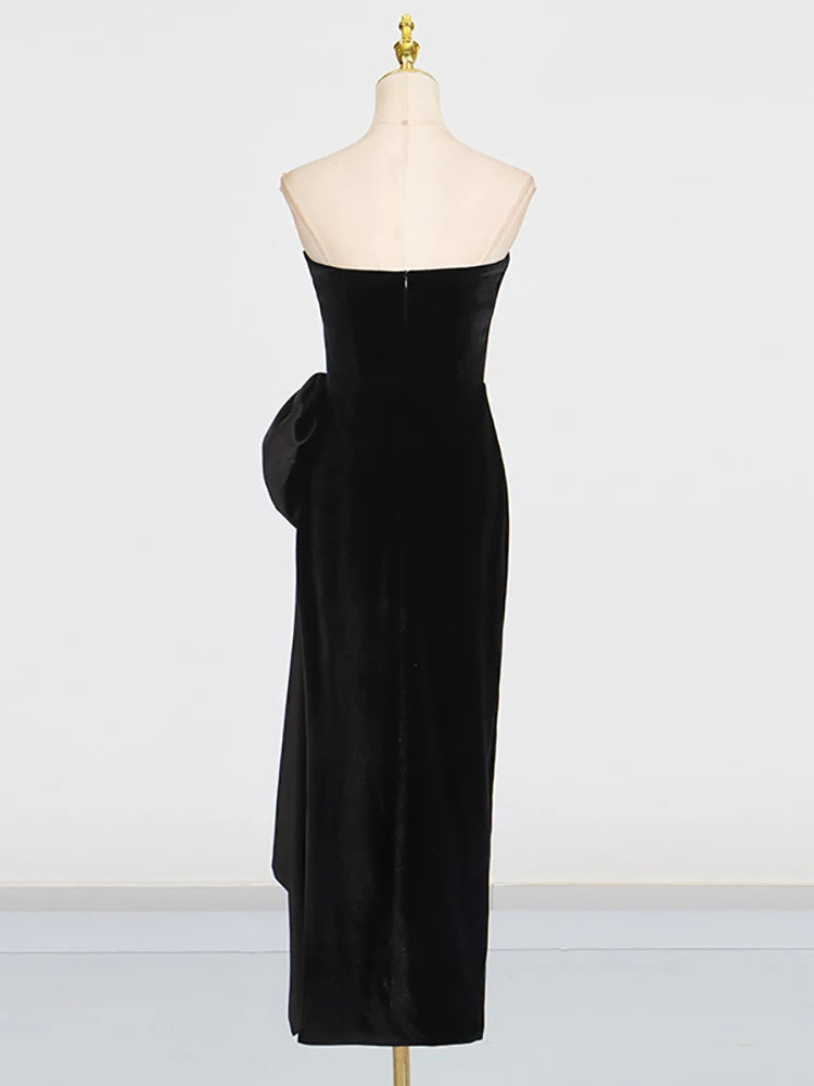 Black strapless dress on a mannequin against a white background