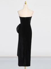 Black strapless dress on a mannequin against a white background