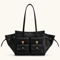 Black leather handbag with gold accents on a white background