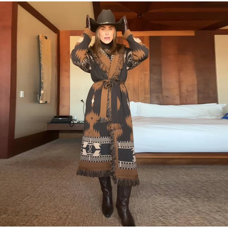 Woman in a patterned dress and cowboy hat in a bedroom setting