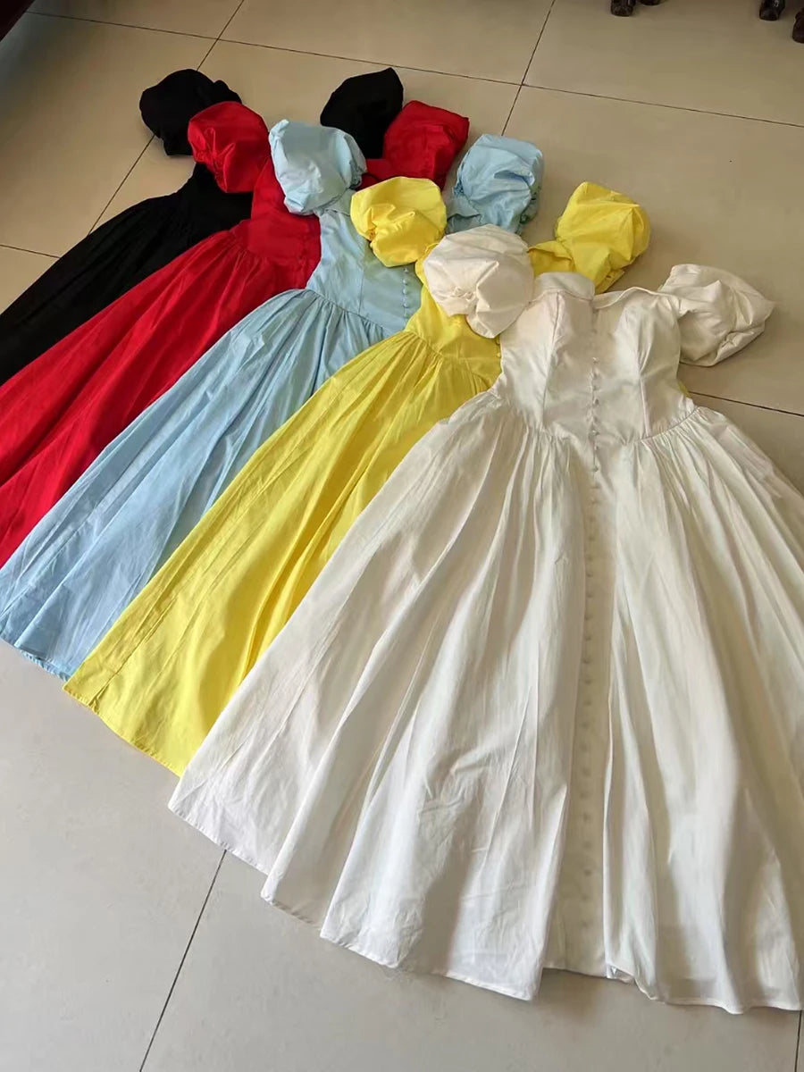 Collection of colorful dresses on a tiled floor