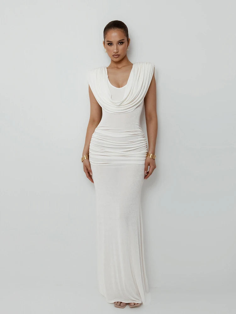 Woman wearing a white evening gown against a plain background