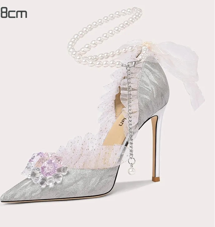 High-heeled shoe with decorative elements on a white background