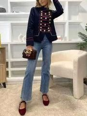 Full body shot of a woman in a military jacket and jeans