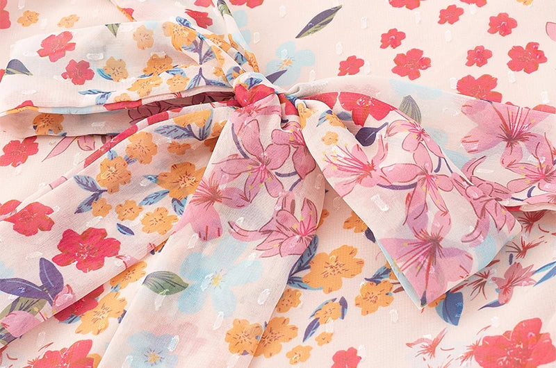 Close-up detail of the tie and fabric texture on the midi dress.