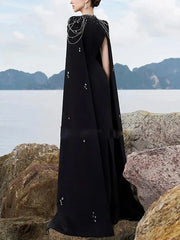 Back view of black maxi dress with cape sleeves