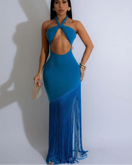 Woman wearing a blue fringe dress with a plain background