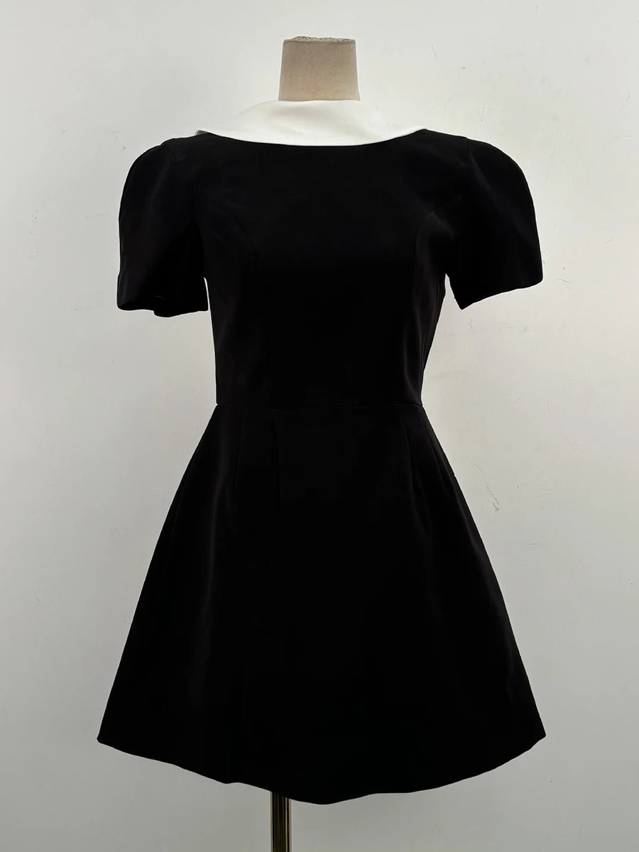 Black dress on a mannequin against a white background