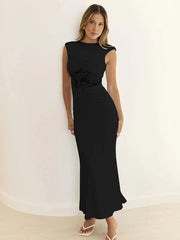 Woman wearing a black dress against a white background