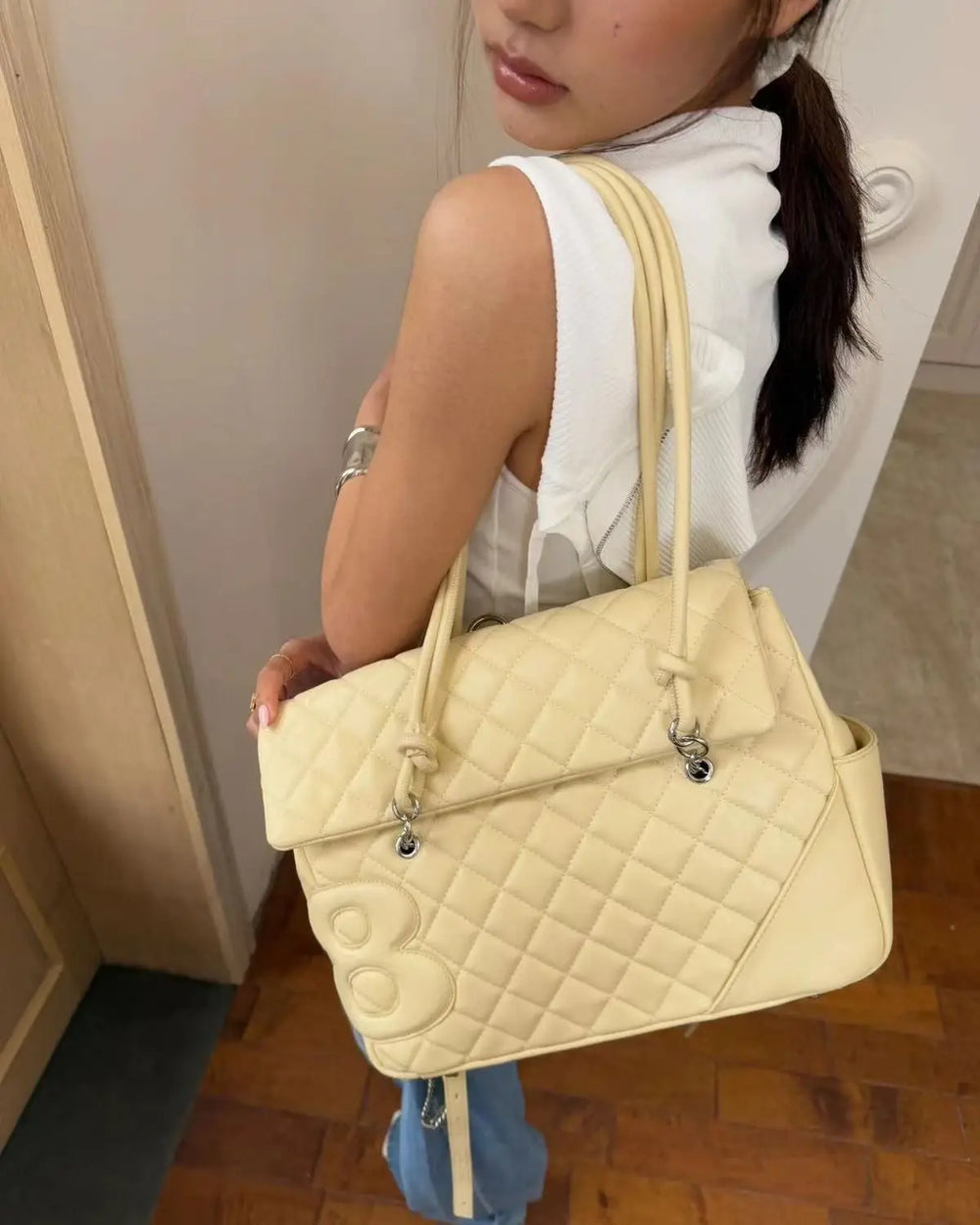 Close-up of the quilted satchel shoulder bag detail.