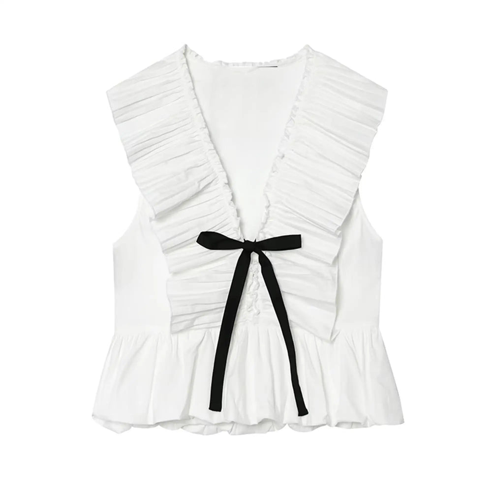 White sleeveless peplum top with a black bow tie, displayed flat.