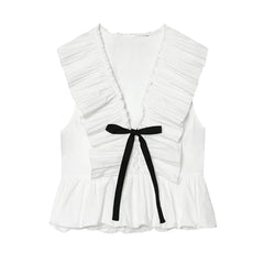 White sleeveless peplum top with a black bow tie, displayed flat.