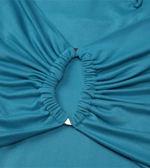 Close-up of a blue fabric with a pleated design on a light gray background