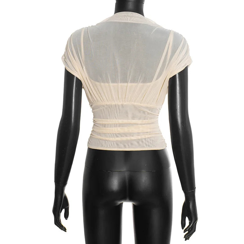 Mannequin wearing a beige sheer top on a white background