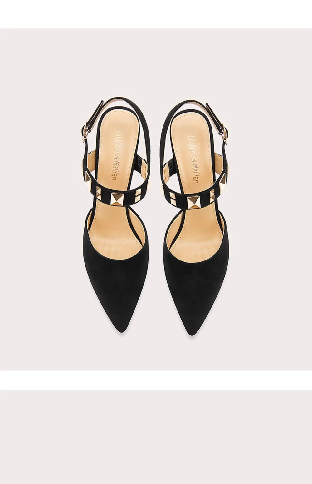 Pair of black high-heeled shoes with thin straps on a light gray background